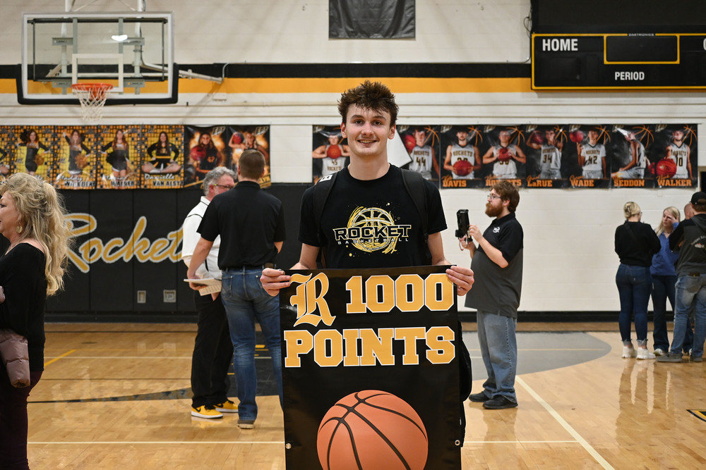 Image of EBF junior Brooks Moore with his 1000 point sign
