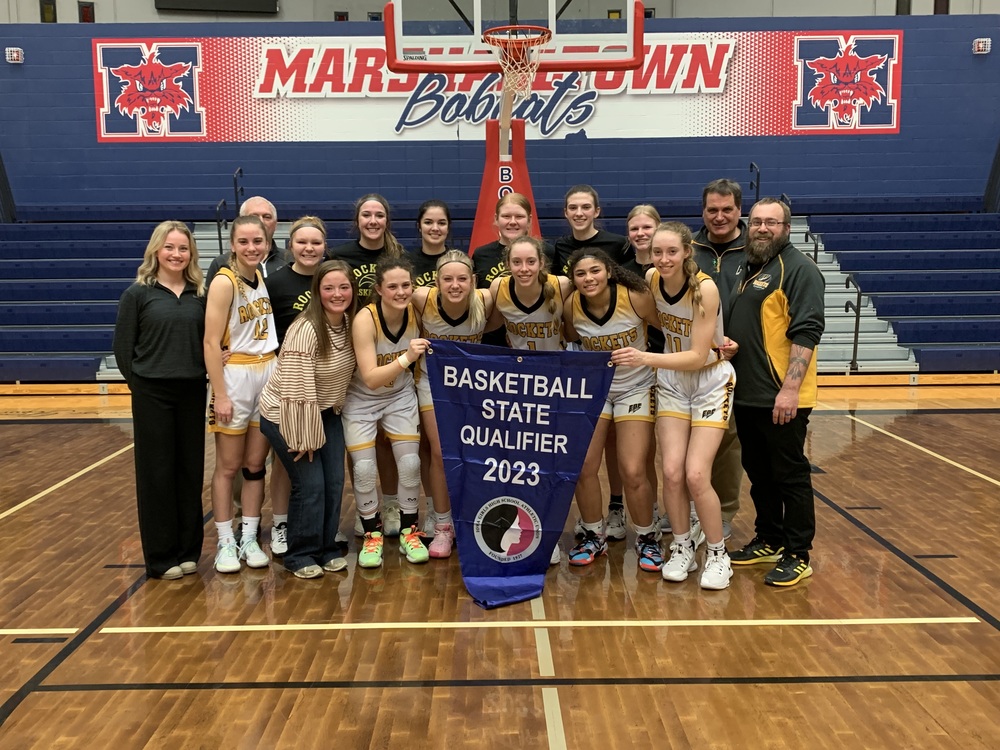 image of EBF girls basketball team with state qualifying banner