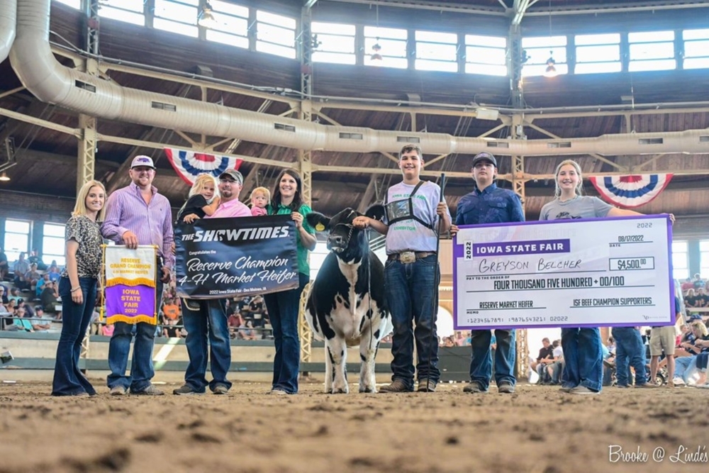 Picture of Greyson Belcher, Reserve Grand Champion, with his Heifer "Cookie" and family at the 2022 Iowa State Fair